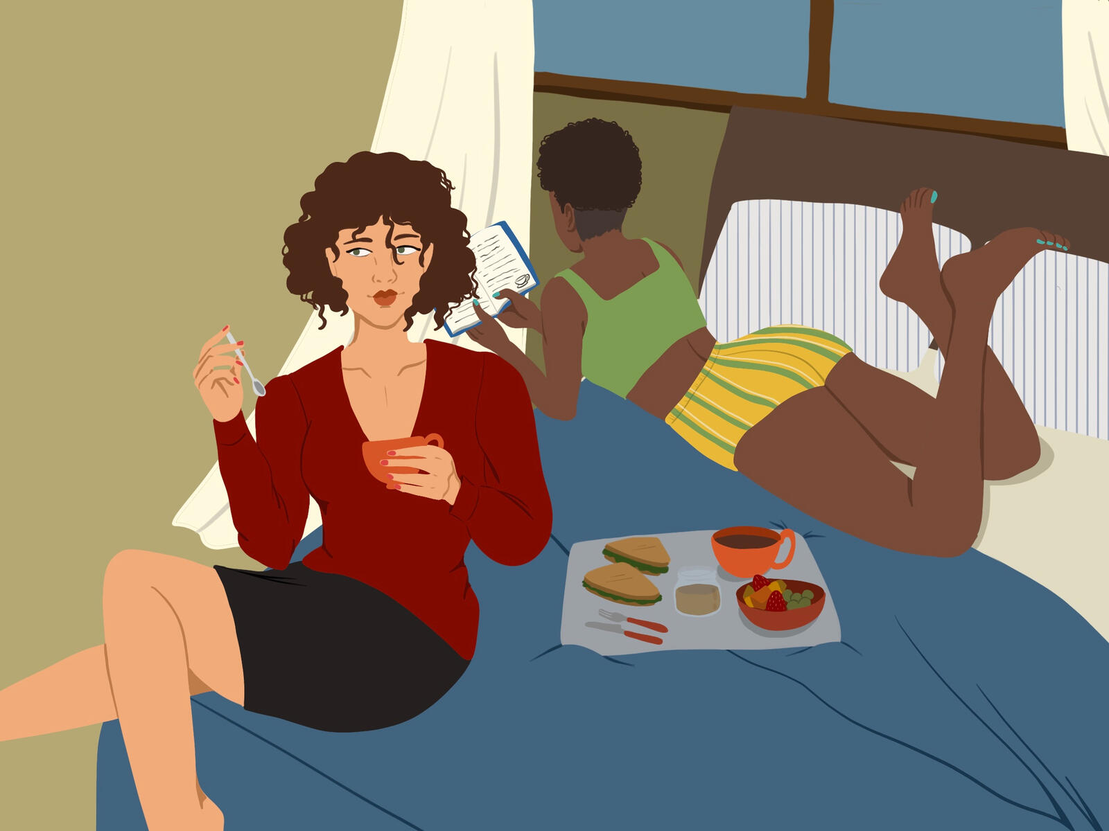 Two ladies enjoying a cozy day with some tea and snacks indoors.